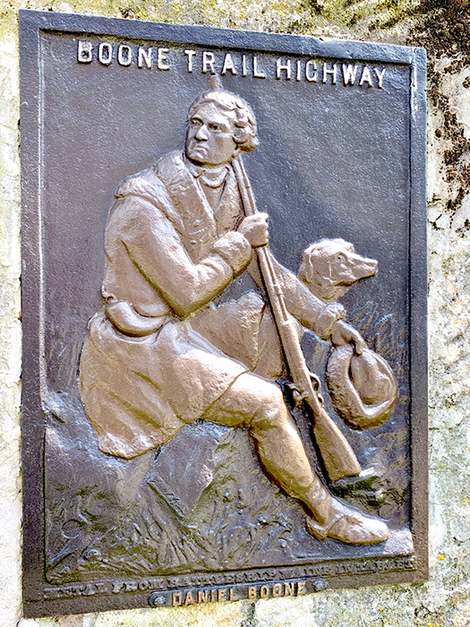 Bronze engraving of a man with a dog